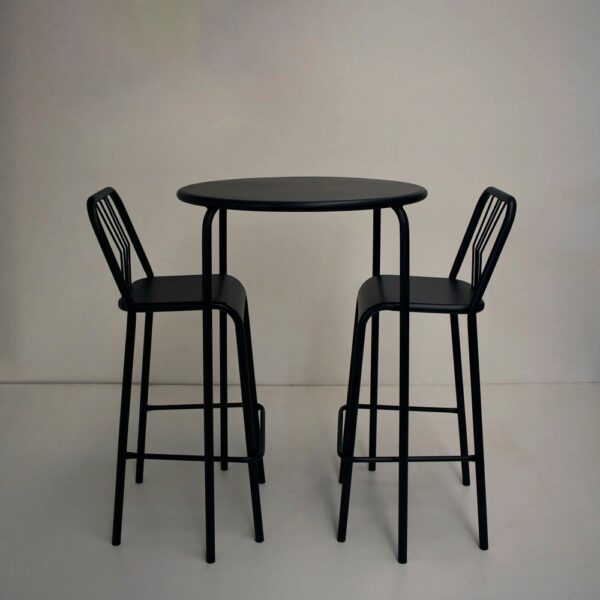 Una barra alta redonda de color negro con dos banquetas altas a juego con respaldo, fabricadas en caño, sobre un fondo neutro.